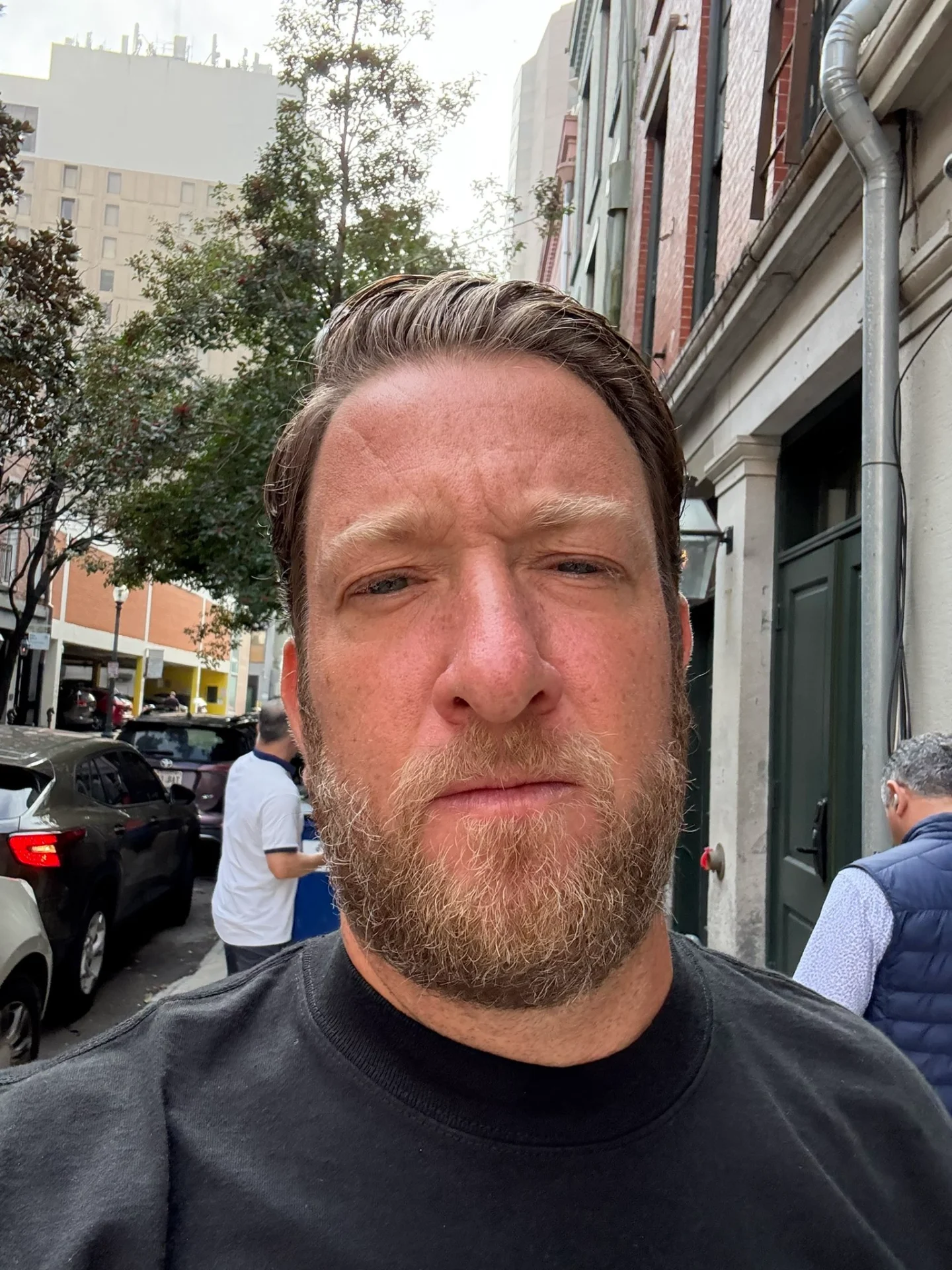 Dave Portnoy poses for a selfie on a street